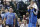 Dallas Mavericks owner Mark Cuban, left, looks on as forward Dirk Nowitzki (41) prepares to sit on the bench during the second half an NBA basketball game against the Minnesota Timberwolves Wednesday, March 19, 2014, in Dallas. (AP Photo/LM Otero)
