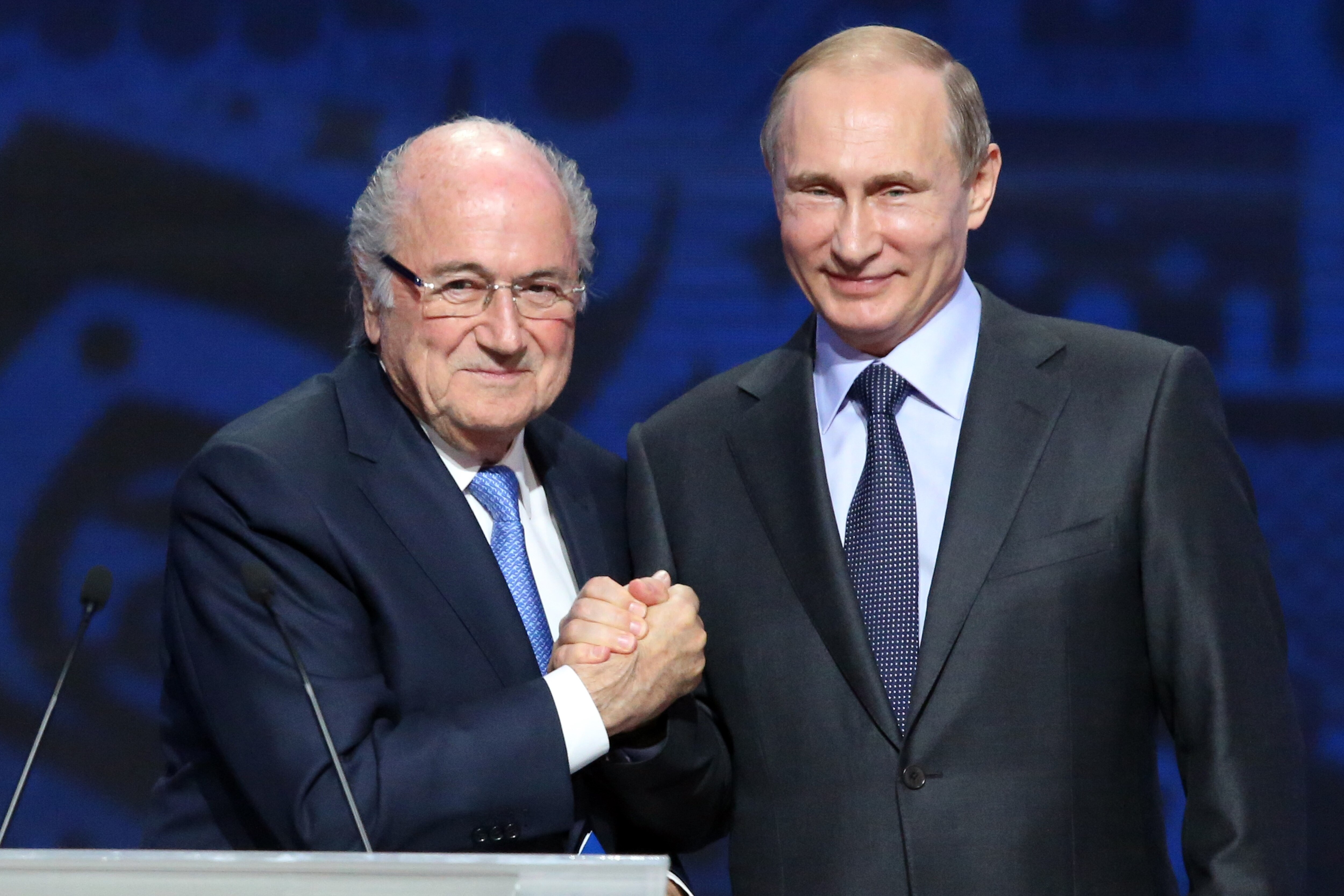 Outgoing FIFA president Sepp Blatter shakes hands with Russian President Vladimir Putin (R) ahead of the preliminary draw for the 2018 World Cup qualifiers at the Konstantin Palace in Saint Petersburg on July 25, 2015. AFP PHOTO / KIRILL KUDRYAVTSEV (Photo credit should read KIRILL KUDRYAVTSEV/AFP/Getty Images)