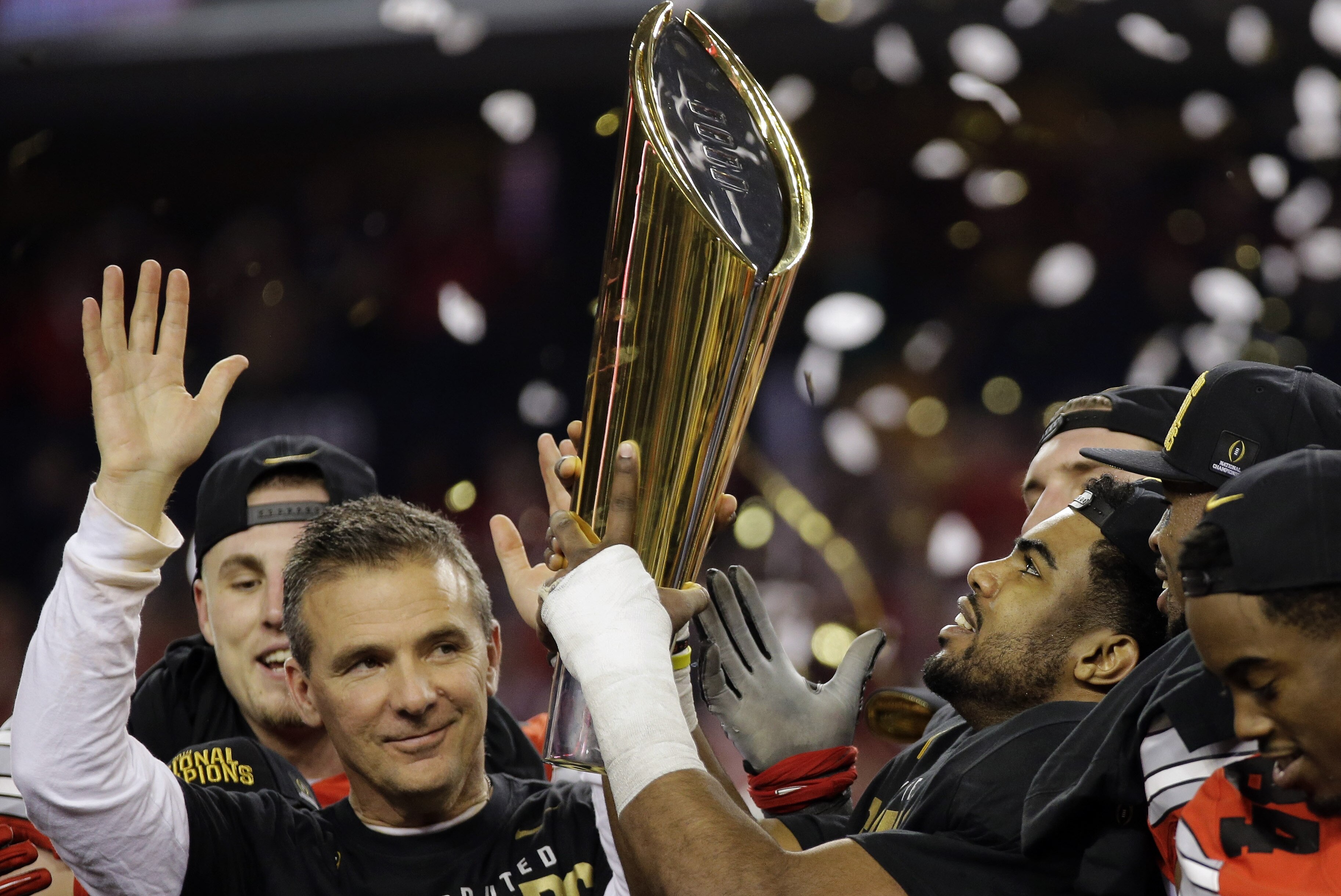 Ohio State head coach Urban Meyer and Ezekiel Elliott celebrate after the NCAA college football playoff championship game against Oregon Monday, Jan. 12, 2015, in Arlington, Texas. Ohio State won 42-20. (AP Photo/Eric Gay)