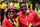 Arsenal's English midfielder Jack Wilshere and Arsenal's English striker Danny Welbeck react during the Arsenal victory parade in London on May 31, 2015, following their win in the English FA Cup final football match on May 30, 2014 against Aston Villa. Arsene Wenger's side made history at Wembley with a 4-0 rout of Aston Villa that underlined their renaissance in the second half of the campaign and served as a warning to English champions Chelsea.     AFP PHOTO / LEON NEAL        (Photo credit should read LEON NEAL/AFP/Getty Images)