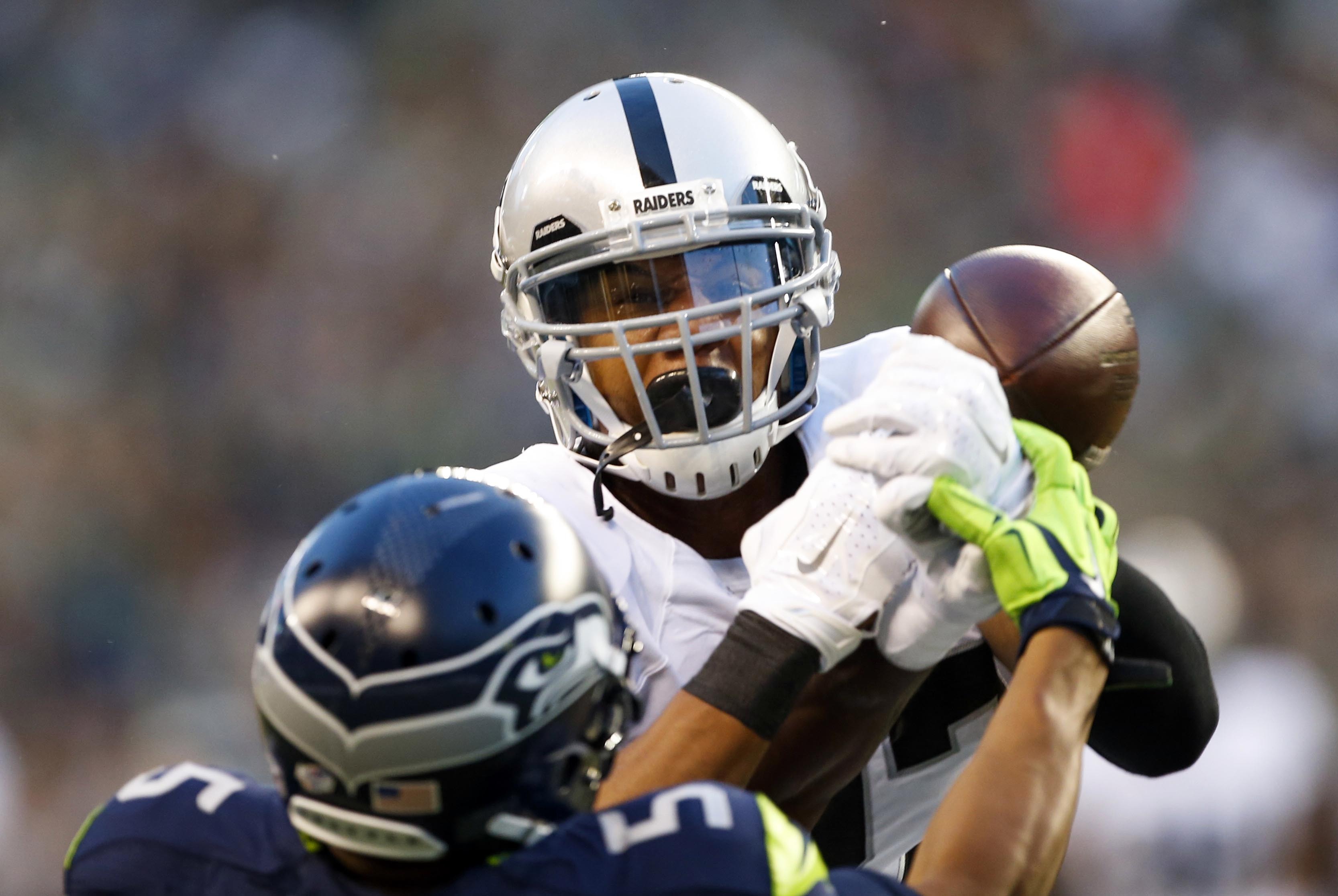 Sep 3, 2015; Seattle, WA, USA; Oakland Raiders safety Taylor Mays (27) breaks up a pass against the Seattle Seahawks during the first quarter at CenturyLink Field. Mandatory Credit: Joe Nicholson-USA TODAY Sports