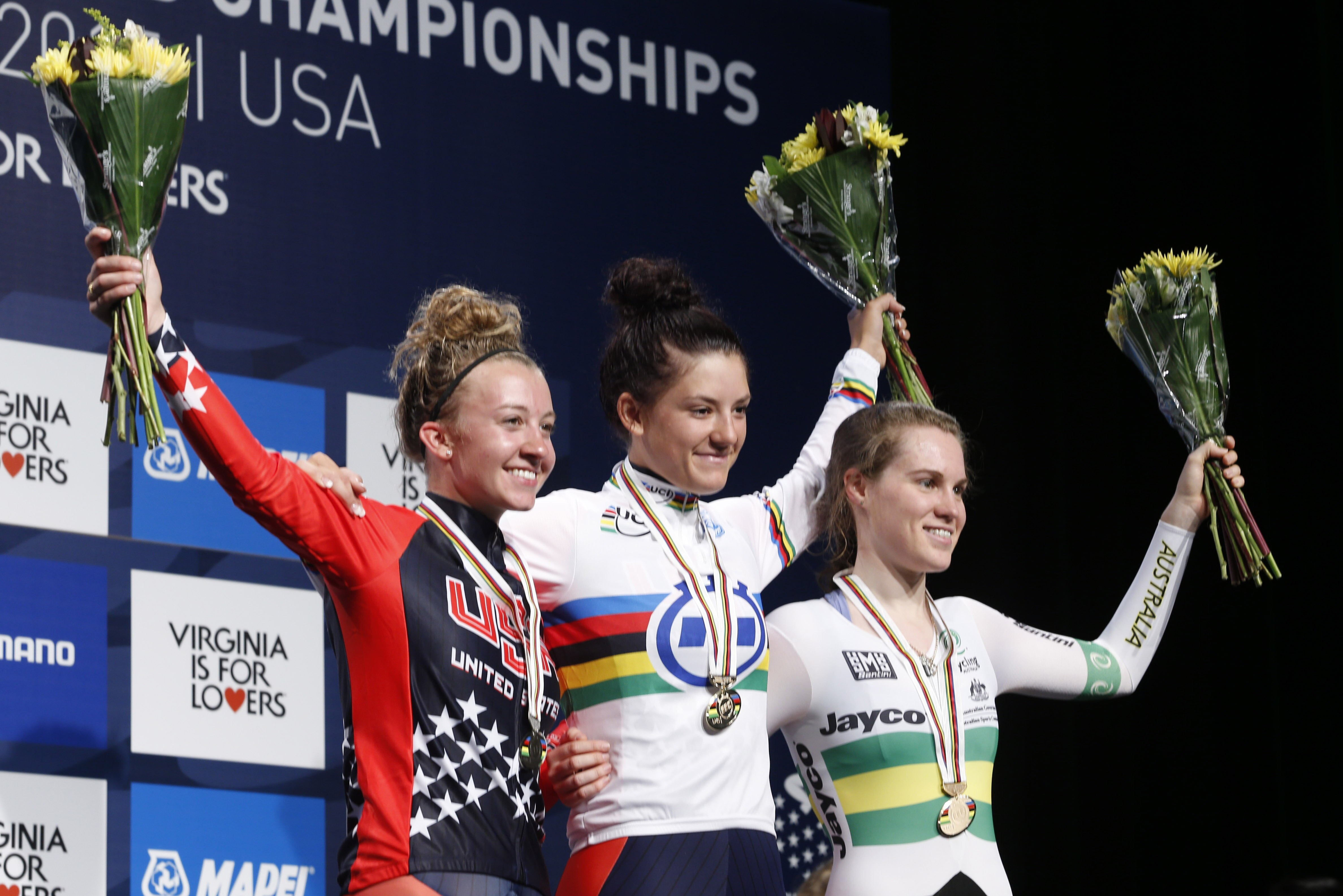 Chloe Dygert, of the United States, center, celebrates her Junior Women's Time Trial win with second place finisher, Emma White, left, of the US and third place finisher, Anna-Leeza Hull, of Australia, right, after the Women's Time Trials for the UCI Road World Championships in Richmond, Va., Monday, Sept. 21, 2015. (AP Photo/Steve Helber)
