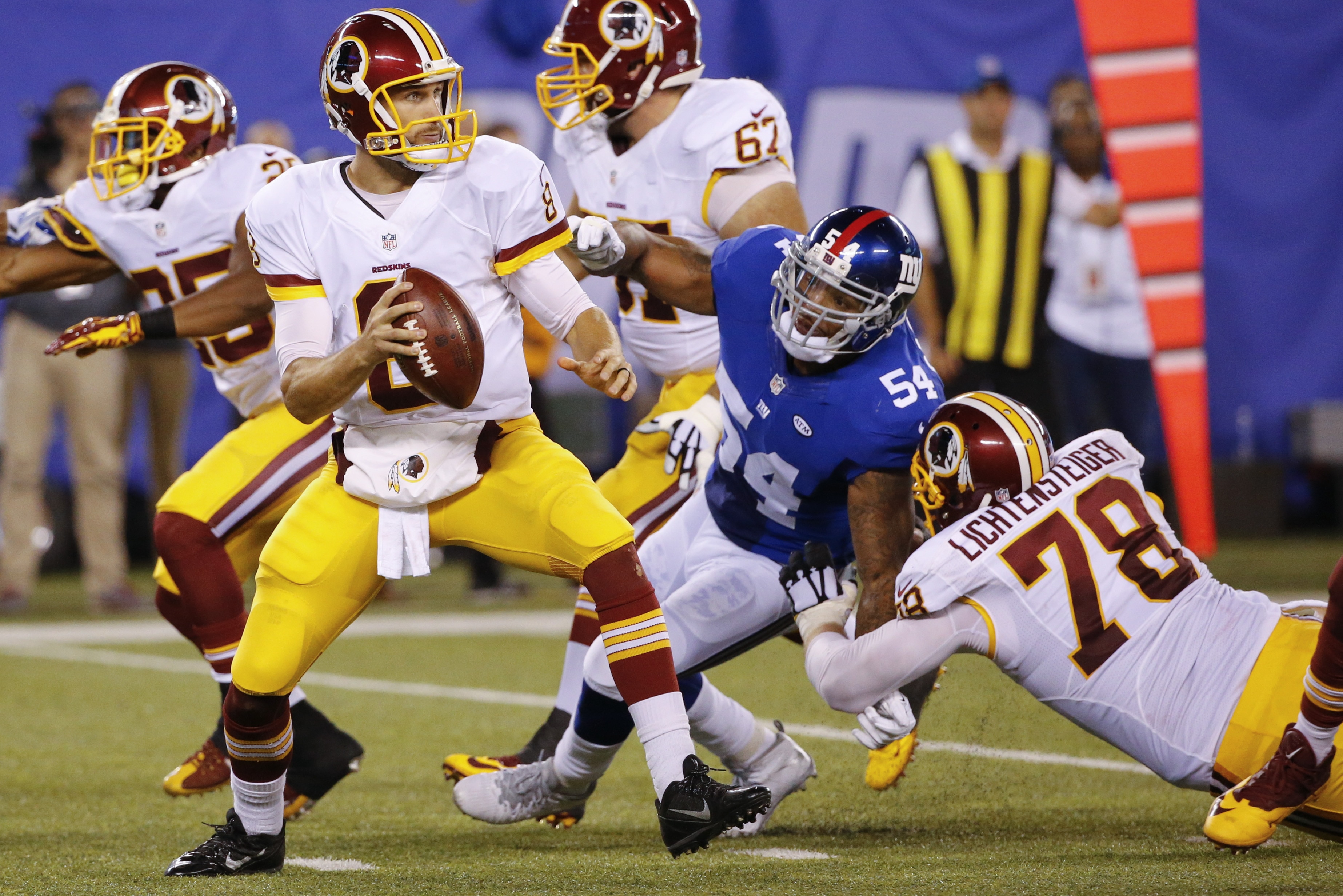Washington Redskins center Kory Lichtensteiger (78) blocks New York Giants' Jonathan Casillas (54) as quarterback Kirk Cousins (8) looks to pass during the first half an NFL football game Thursday, Sept. 24, 2015, in East Rutherford, N.J. (AP Photo/Kathy Willens)