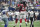 Dallas Cowboys' Nick Hayden (96) walks to the sideline as Atlanta Falcons' Julio Jones, rear, and Devonta Freeman (24) celebrate a touchdown by Jones during the second half of an NFL football game Sunday, Sept. 27, 2015, in Arlington, Texas. Umpire Ruben Fowler (71) walks the ball back downfield. (AP Photo/Michael Ainsworth )