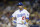 Los Angeles Dodgers first baseman Adrian Gonzalez walks back to the dugout after striking out against the Colorado Rockies during the first inning of a baseball game, Monday, Sept. 14, 2015, in Los Angeles. (AP Photo/Danny Moloshok)