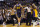 A referee separates Utah Jazz forward Trevor Booker (33), left, and Los Angeles Lakers center Roy Hibbert (17), far right, after an altercation between the players during the second half of an NBA preseason basketball game, Tuesday, Oct. 6, 2015, in Honolulu.  Booker was ejected from the game and a technical foul was called on Hibbert.  (AP Photo/Marco Garcia)
