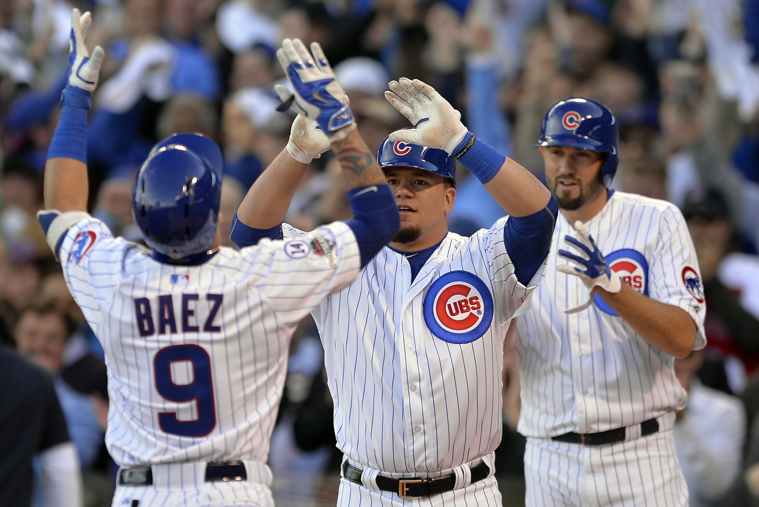 Chicago Cubs' Javier Baez (9) celebrates a three-run home run with Kyle Schwarber and Jason Hammel, right, of Game 4 in baseball's National League Division Series against the St. Louis Cardinals, Tuesday, Oct. 13, 2015, in Chicago. (AP Photo/Paul Beaty)