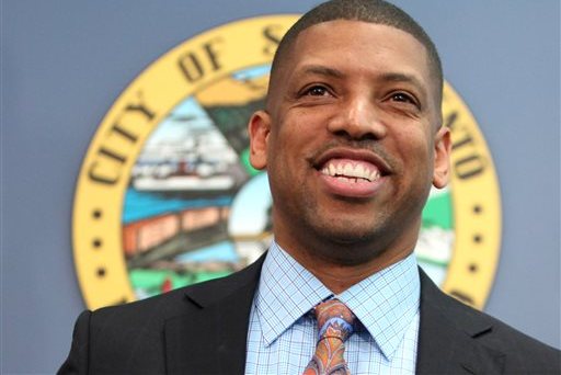 FILE - In this Feb. 22, 2012, file photo, Sacramento Mayor Kevin Johnson smiles during a news conference in Sacramento, Calif. Johnson, 48, has been on a winning streak keeping the Sacramento Kings from relocating to Seattle, serving as the new leader of the U.S. Conference of Mayors and representing the NBA players in the Sterling scandal surrounding Los Angeles Clippers Donald Sterling.(AP Photo/Rich Pedroncelli, File)