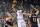 Utah Jazz guard Alec Burks (10) shoots as Portland Trail Blazers' Mason Plumlee (24) and Meyers Leonard (11) defends during the first quarter of an NBA preseason basketball game Monday, Oct. 12, 2015, in Salt Lake City. (AP Photo/Rick Bowmer)