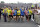 A group of the approximately 35 runners from the 2013 Boston Marathon, unable to finish the race due to the tragic bombings, complete the distance by crossing finish line at the Indianapolis Motor Speedway before the start of the 97th Indianapolis 500 auto race. (AP Photo/Michael Conroy)