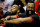 Houston Rockets' James Harden laughs from the bench during the first half of an NBA  preseason basketball game against the Phoenix Suns, Tuesday, Oct. 13, 2015, in Phoenix. (AP Photo/Matt York)