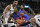 Detroit Pistons guard Reggie Jackson, center, prepares to shoot against San Antonio Spurs forward Tim Duncan, left, and Spurs guard Danny Green during the first half of a preseason NBA basketball game, Sunday, Oct. 18, 2015, in San Antonio. (AP Photo/Darren Abate)