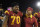 Southern California interim head coach Clay Helton, right, puts his arm around Southern California offensive tackle Chuma Edoga as they walk off the field after USC defeated Utah 42-24 in a NCAA college football game, Saturday, Oct. 24, 2015, in Los Angeles. (AP Photo/Mark J. Terrill)
