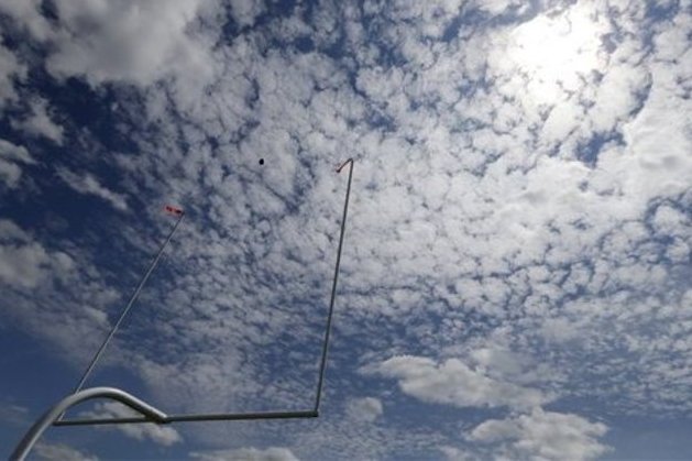 A ball goes through the goal post uprights during Minnesota Vikings NFL football training camp, Monday, July 29, 2013, in Mankato, Minn. (AP Photo/Charlie Neibergall)