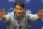 Michael Phelps gestures as he speaks with media members after practicing for the U.S. Winter Nationals swimming event Wednesday, Dec. 2, 2015, in Federal Way, Wash. Phelps will put a cap on his 2015 season at the event this week. It's his final opportunity to show just where his comeback is at before the Olympic year arrives. (AP Photo/Elaine Thompson)