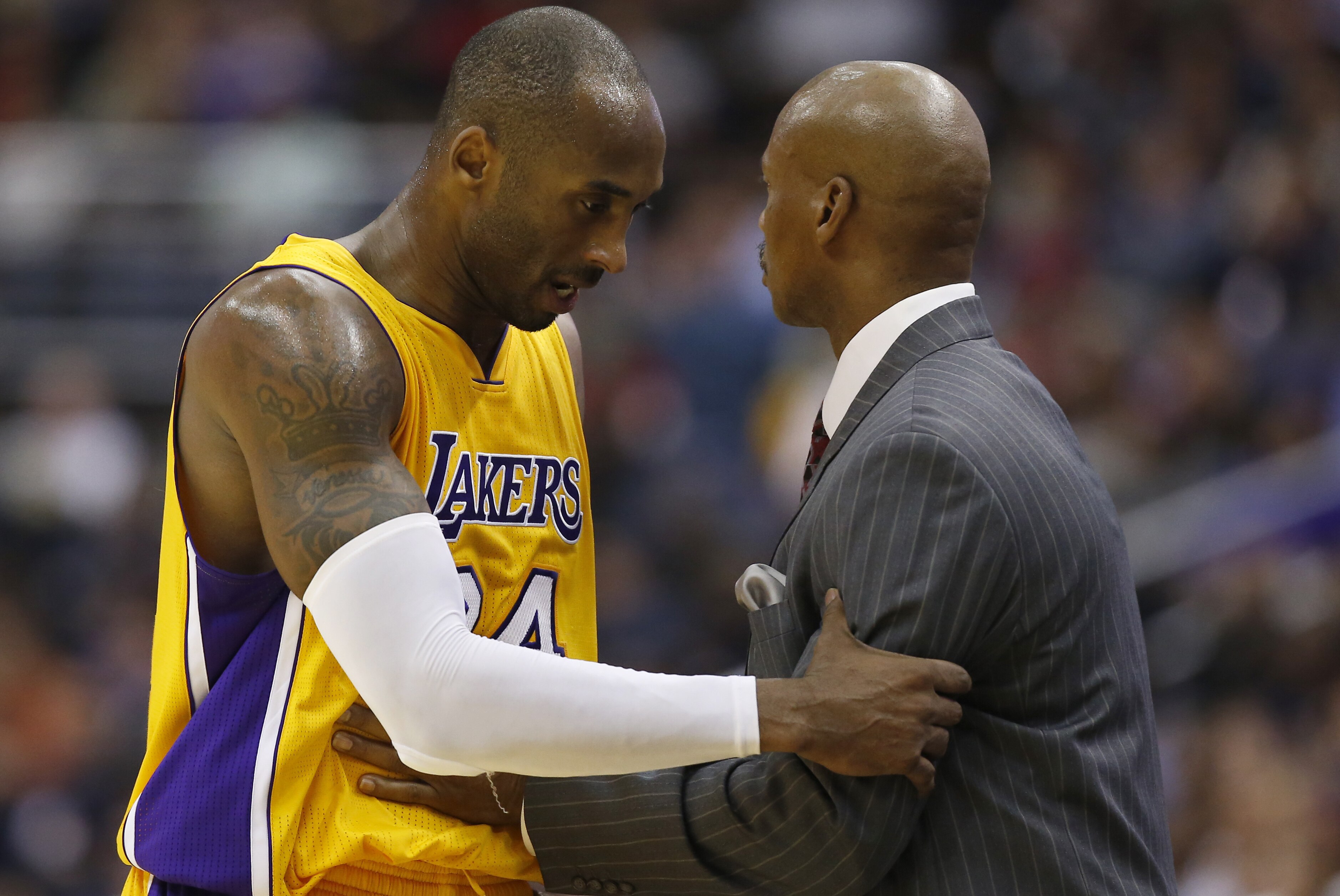 Los Angeles Lakers guard Kobe Bryant (24) talks with head coach Byron Scott as while coming out of an NBA basketball game in the second half against the Washington Wizards, Wednesday, Dec. 3, 2014, in Washington. The Wizards won 111-95. (AP Photo/Alex Brandon)