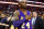 Los Angeles Lakers' Kobe Bryant touches his chest as he walks of the court in Boston after the Lakers' 112-104 win over the Boston Celtics in an NBA basketball game Wednesday, Dec. 30, 2015.(AP Photo/Winslow Townson)