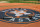 Baseball bats and gloves sit on the tarp with the new Houston Astros logo during batting practice before an exhibition baseball game against the Chicago Cubs Friday, March 29, 2013, in Houston. (AP Photo/Pat Sullivan)