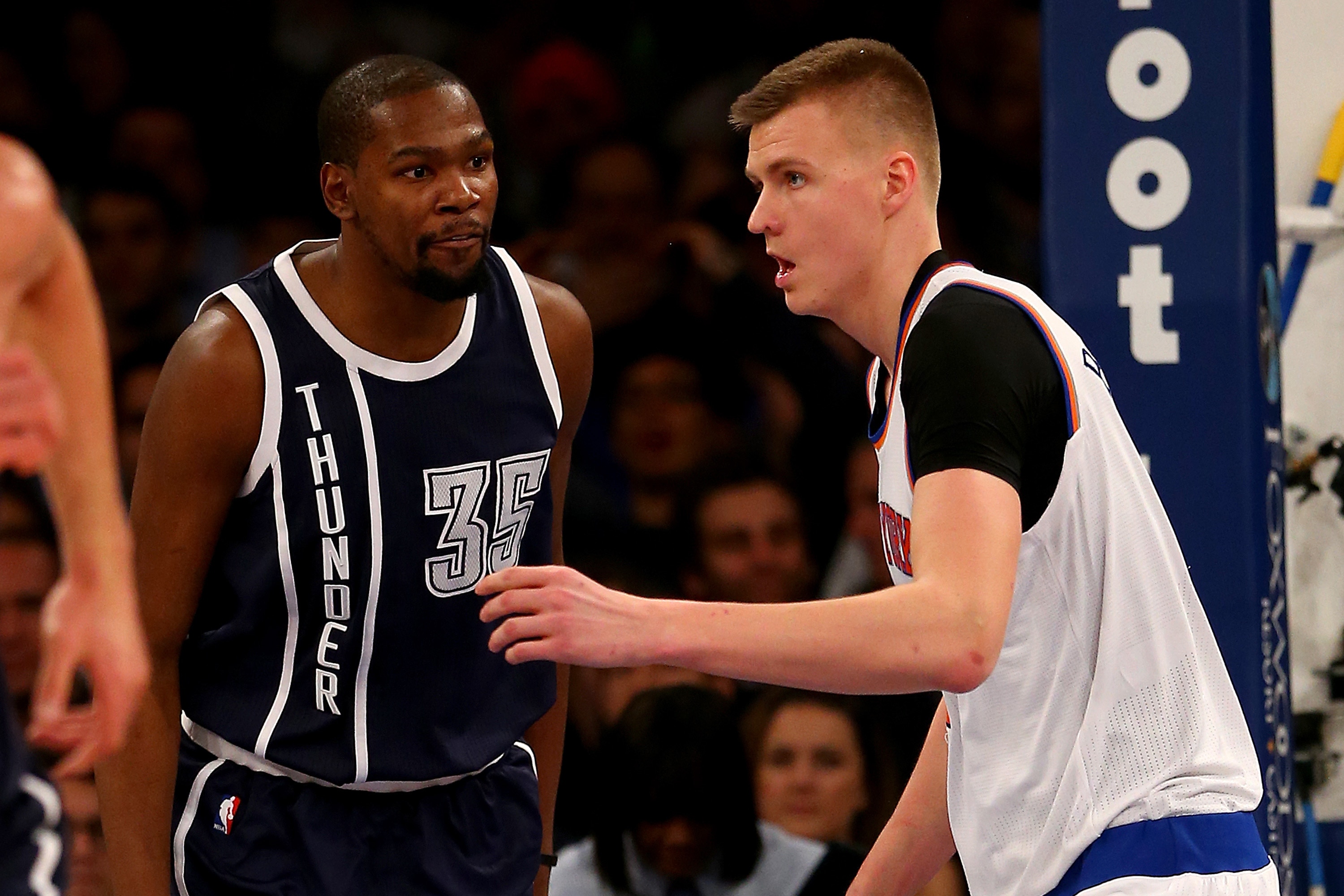NEW YORK, NY - JANUARY 26: Kevin Durant #35 of the Oklahoma City Thunder has words for Kristaps Porzingis #6 of the New York Knicks after Durant dunked the ball over him in the second half at Madison Square Garden on January 26, 2016 in New York City.The Oklahoma City Thunder defeated the New York Knicks 128-122 in overtime. NOTE TO USER: User expressly acknowledges and agrees that, by downloading and or using this photograph, User is consenting to the terms and conditions of the Getty Images License Agreement. (Photo by Elsa/Getty Images)