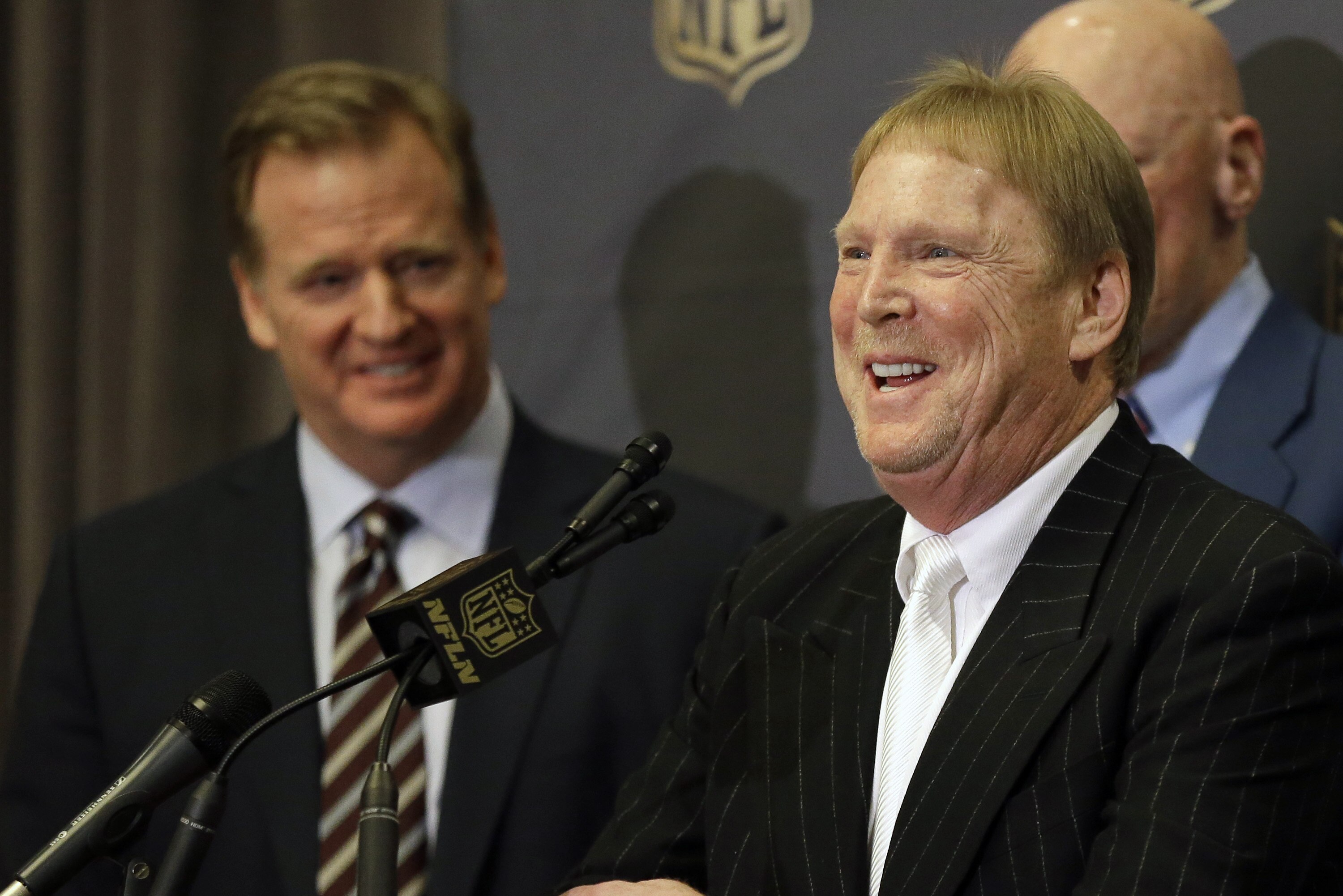 NFL Commissioner Roger Goodell, left, laughs as Oakland Raiders owner Mark Davis talks to the media after an NFL owners meeting Tuesday, Jan. 12, 2016, in Houston. The owners voted to allow the St. Louis Rams to move to a new stadium just outside Los Angeles, and the San Diego Chargers will have an option to share the facility. The Raiders, who also wanted to move to the area, could move to Los Angeles if San Diego doesn't. (AP Photo/Pat Sullivan)
