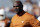 Texas head coach Charlie Strong watches his team warm up before an NCAA college football game against Oklahoma Saturday, Oct. 10, 2015, in Dallas. (AP Photo/LM Otero)