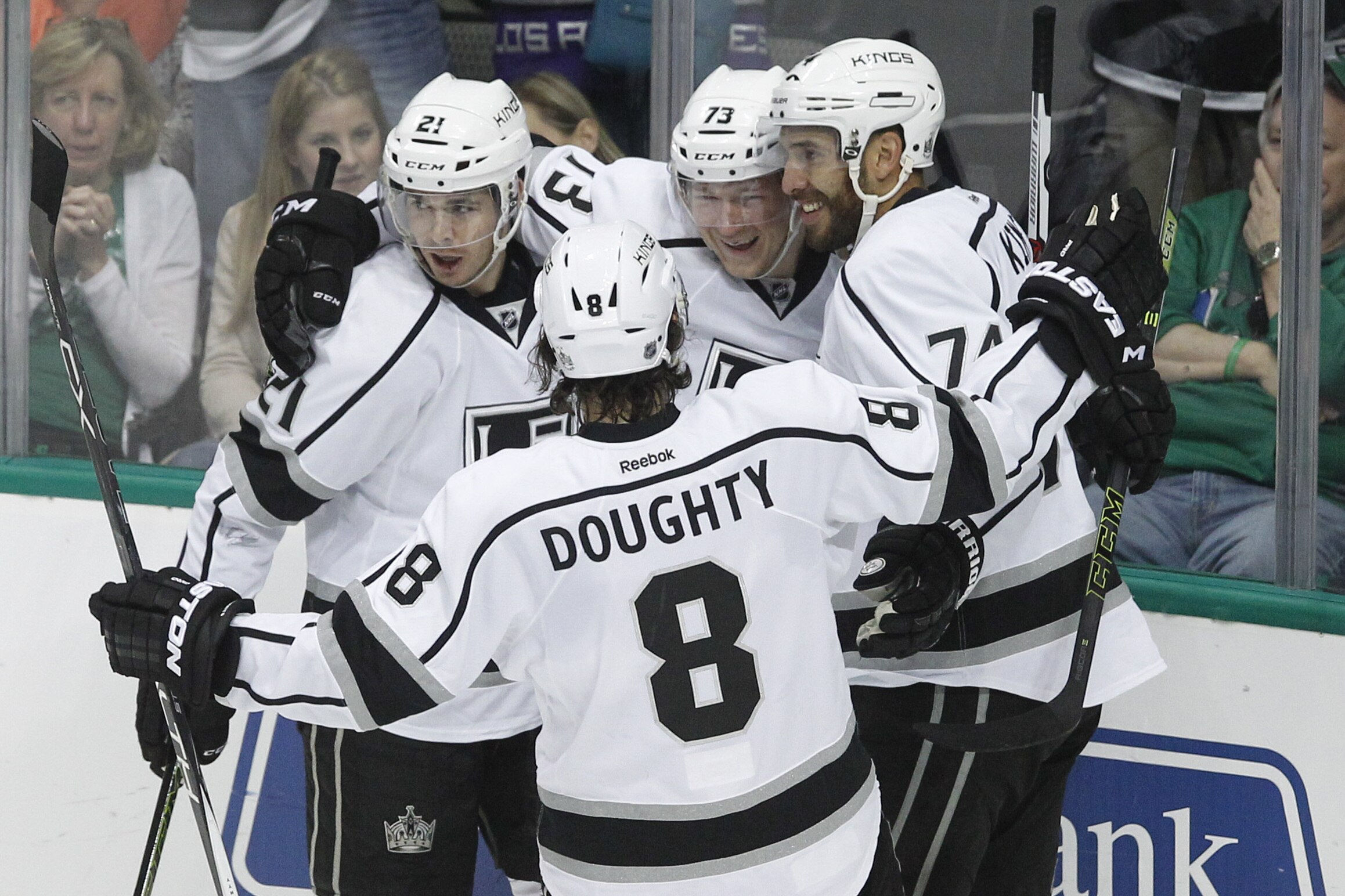 Los Angeles Kings center Tyler Toffoli, center, is congratulated Nick Shore (21), left wing Dwight King (74) and defenseman Drew Doughty (8) after scoring a goal against the Dallas Stars during the first period of an NHL hockey game Tuesday, March 15, 2016, in Dallas. Los Angeles won 5-2. (AP Photo/Tim Sharp)