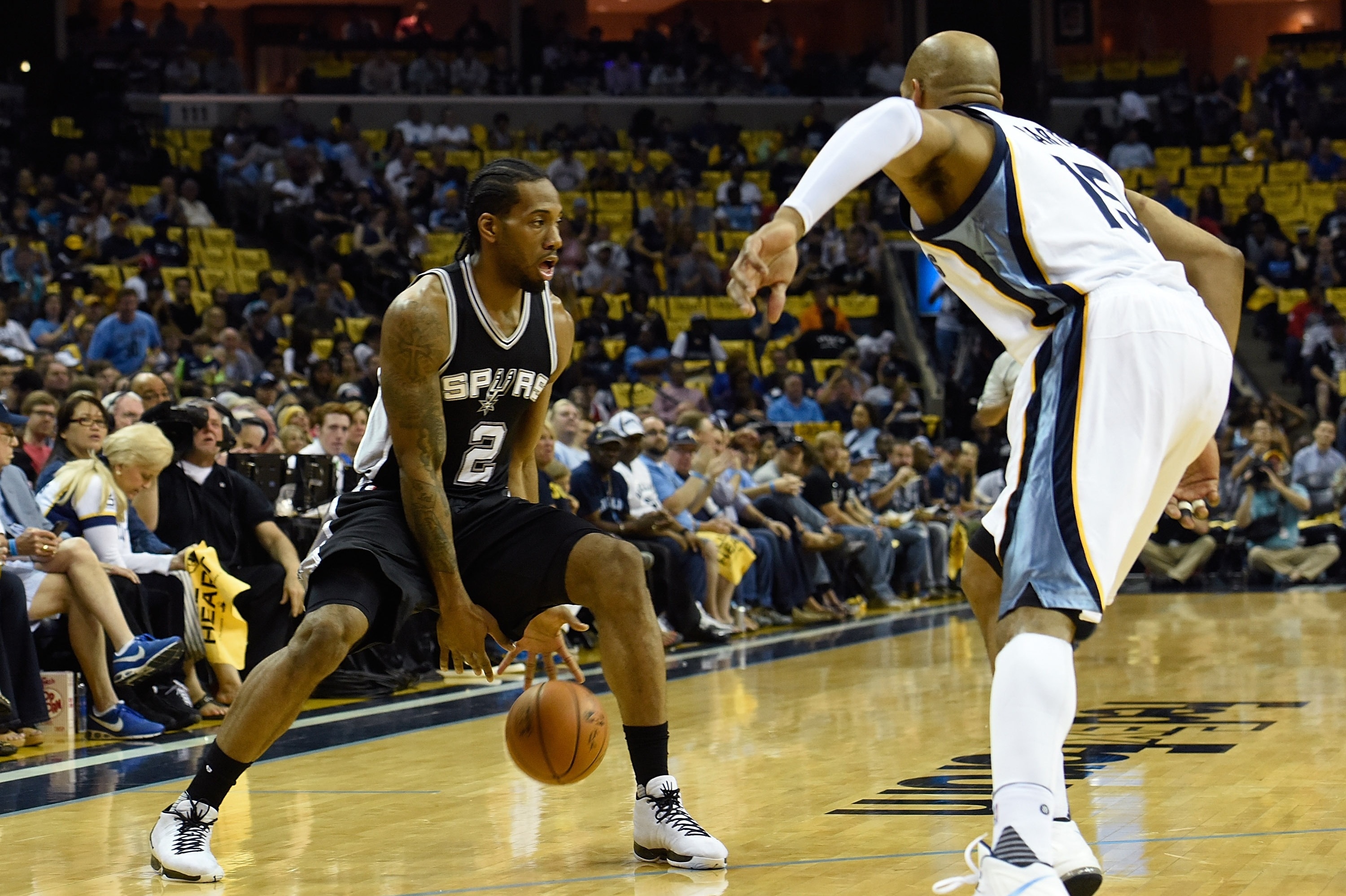 MEMPHIS, TN - APRIL 24: Kawhi Leonard #2 of the San Antonio Spurs dribbles against Vince Carter #15 of the Memphis Grizzlies during the first half of Game Four of the First Round of the NBA Playoffs at FedExForum on April 24, 2016 in Memphis, Tennessee. NOTE TO USER: User expressly acknowledges and agrees that, by downloading and or using this photograph, User is consenting to the terms and conditions of the Getty Images License Agreement. (Photo by Frederick Breedon/Getty Images)