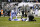 Indianapolis Colts wide receiver Austin Collie, center, lies on the field after being injured as teammate Reggie Wayne, left, and a trainer look on in the first half of an NFL football game against the Philadelphia Eagles, Sunday, Nov. 7, 2010 in Philadelphia. (AP Photo/Miles Kennedy)
