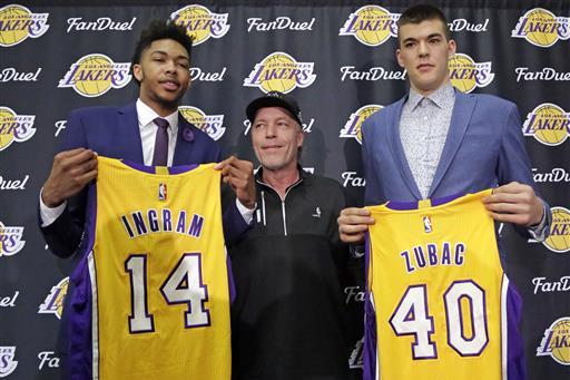 The Los Angeles Lakers' No. 2 draft pick Brandon Ingram, left, and Ivaca Subac, of Croatia, selected No. 32 in the second round, pose with Lakers owner Jim Buss are introduced at the NBA basketball team's headquarters in El Segundo, Calif., Tuesday, July 5, 2016. The Lakers believe Ingram will be a big piece of their next title-contending roster. Ingram, the smooth-shooting forward begins summer league practices this week, and the rebuilding franchise gets a glimpse of its future. (AP Photo/Reed Saxon)