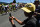 A child, wearing a cap with the Tour de France logo, takes pictures with a smartphone as cyclists ride past him during the 160 km fifteenth stage of the 103rd edition of the Tour de France cycling race on July 17, 2016 between Bourg-en-Bresse and Culoz. / AFP / jeff pachoud        (Photo credit should read JEFF PACHOUD/AFP/Getty Images)