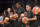 FILE - In this Wednesday, July 13, 2016 file photo, members of the New York Liberty basketball team await the start of a game against the Atlanta Dream, in New York. The WNBA has fined the New York Liberty, Phoenix Mercury and Indiana Fever and their players for wearing plain black warm-up shirts in the wake of recent shootings by and against police officers. All three teams were fined $5,000 and each player was fined $500. While the shirts were the Adidas brand - the official outfitter of the league - WNBA rules state that uniforms may not be altered in any way. (AP Photo/Mark Lennihan, File)