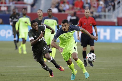 Liverpool's Dejan Lovren (6) chases the ball as AC Milan's Luiz Adriano pursues during the first half of an International Champions Cup soccer match Saturday, July 30, 2016, in Santa Clara, Calif. (AP Photo/Marcio Jose Sanchez)