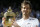 Andy Murray of Britain holds the trophy after beating Milos Raonic of Canada in the men's singles final on day fourteen of the Wimbledon Tennis Championships in London, Sunday, July 10, 2016. (AP Photo/Kirsty Wigglesworth)
