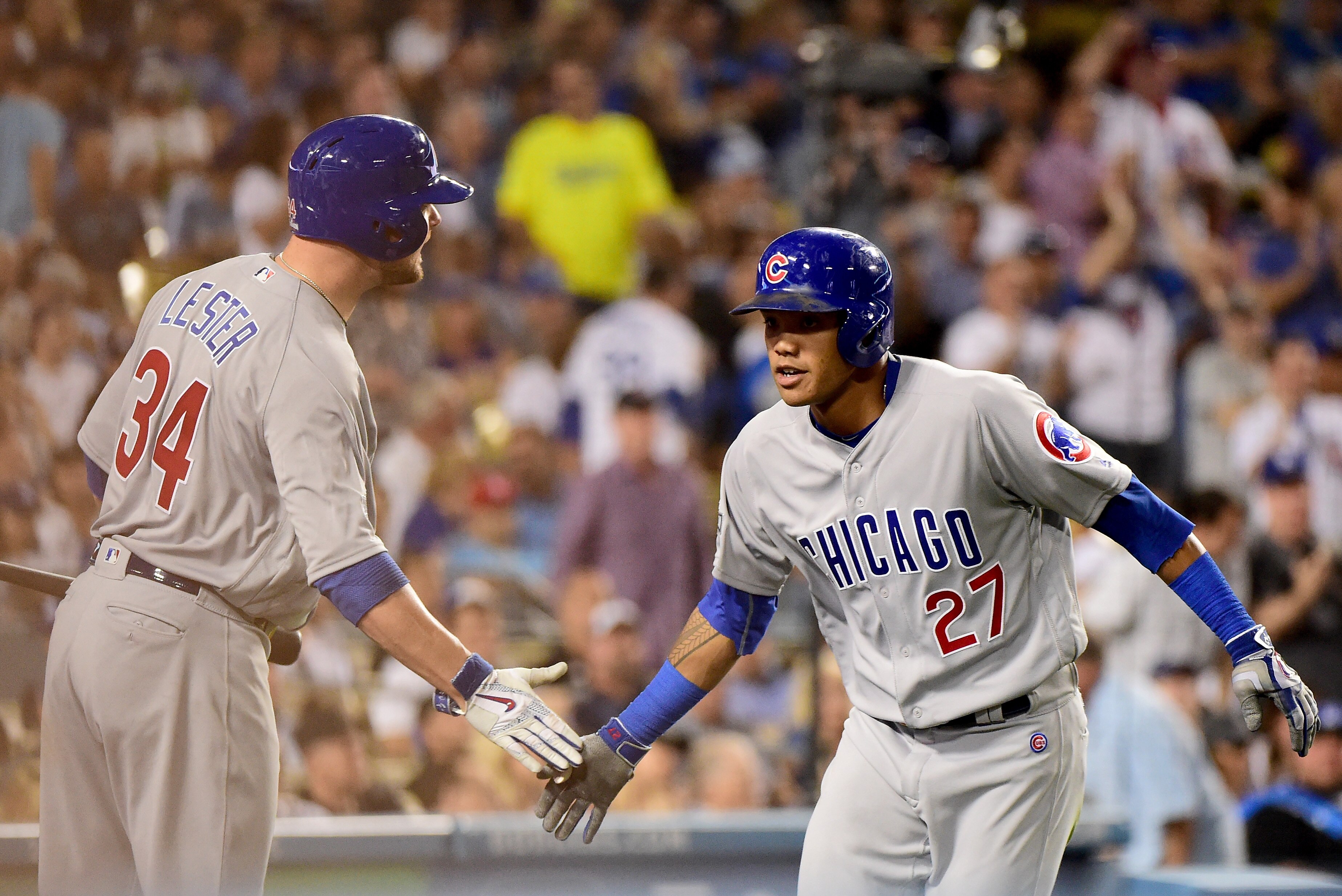 LOS ANGELES, CA - OCTOBER 20: Addison Russell #27 celebrates with Jon Lester #34 of the Chicago Cubs after hitting a two-run home run in the sixth inning against the Los Angeles Dodgers in game five of the National League Division Series at Dodger Stadium on October 20, 2016 in Los Angeles, California. (Photo by Harry How/Getty Images)