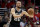 File-This April 19, 2015, file photo shoes San Antonio Spurs guard Manu Ginobili passing against the Los Angeles Clippers during the second half of Game 1 of a first-round NBA basketball  playoff series in Los Angeles. Ginobili says he is returning to the San Antonio Spurs for a 14th season. Ginobili made the announcement on Twitter on Monday, July 6, 2015. The Argentinian will turn 38 later this month and is coming off of a season in which he battled several injuries.(AP Photo/Chris Carlson, File)