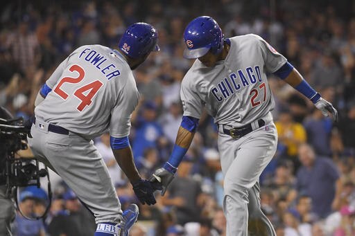 Chicago Cubs' Addison Russell celebrates his two-run home run with teammate Dexter Fowler during the fourth inning of Game 4 of the National League baseball championship series against the Los Angeles Dodgers Wednesday, Oct. 19, 2016, in Los Angeles. (AP Photo/Mark J. Terrill)