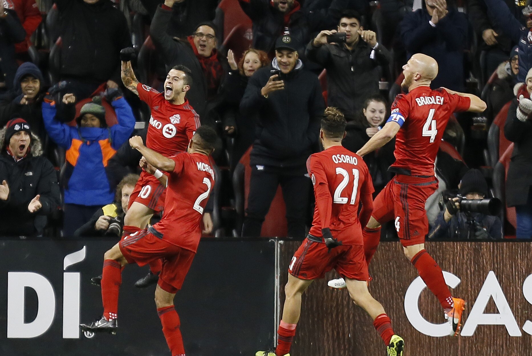 Oct 26, 2016; Toronto, CANADA; Toronto FC defender Justin Morrow (2) and midfielder Jonathan Osorio (21) and midfielder Michael Bradley (4) celebrate a goal by forward Sebastian Giovinco (left) during the first half against the Philadelphia Union at BMO Field. Mandatory Credit: John E. Sokolowski-USA TODAY Sports