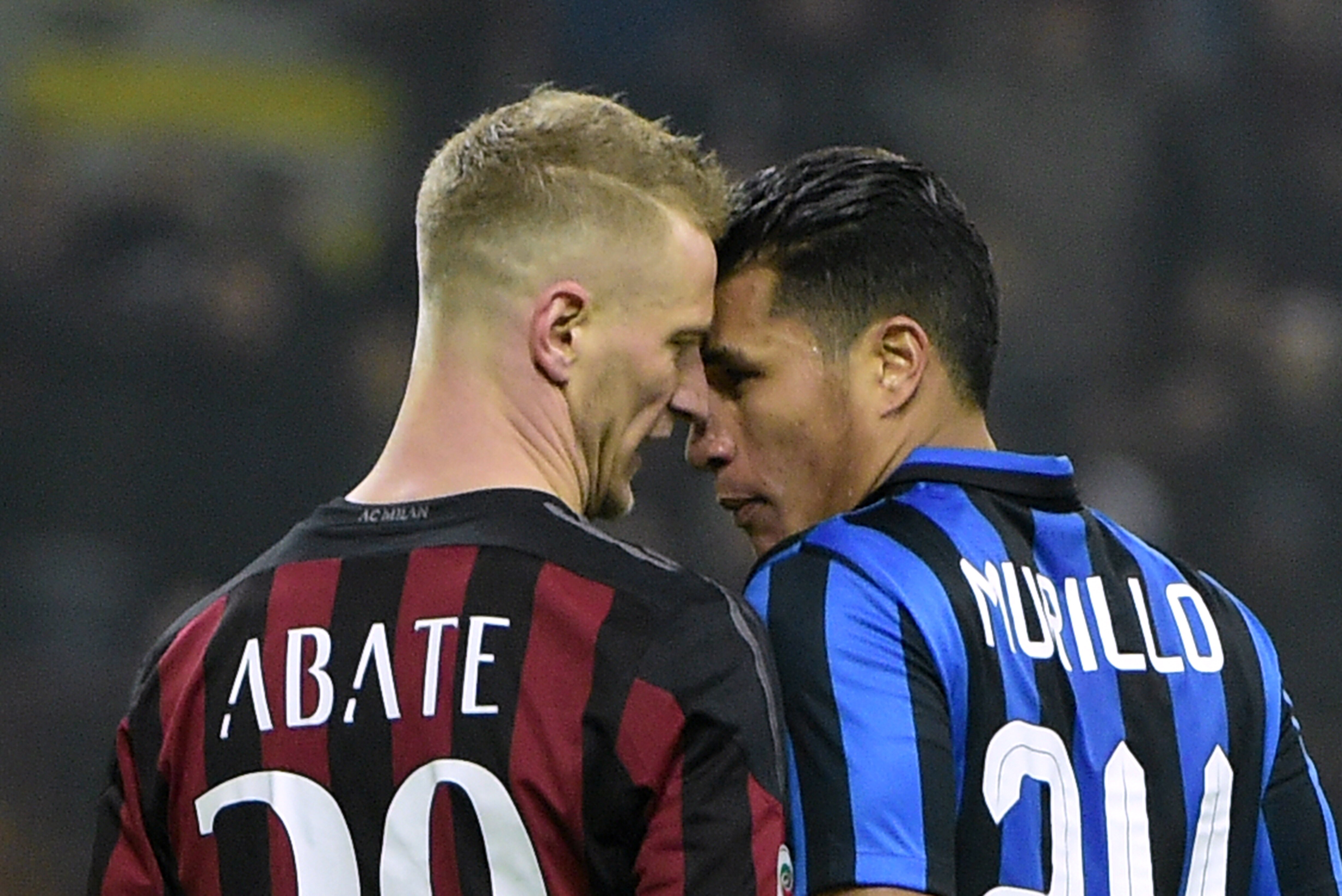AC Milan's Italian defender Ignazio Abate (L) argues with Inter Milan's Colombian defender Jeison Murillo during the Italian Serie A football match between AC Milan and Inter Milan at San Siro Stadium in Milan on January 31, 2016. / AFP / OLIVIER MORIN (Photo credit should read OLIVIER MORIN/AFP/Getty Images)