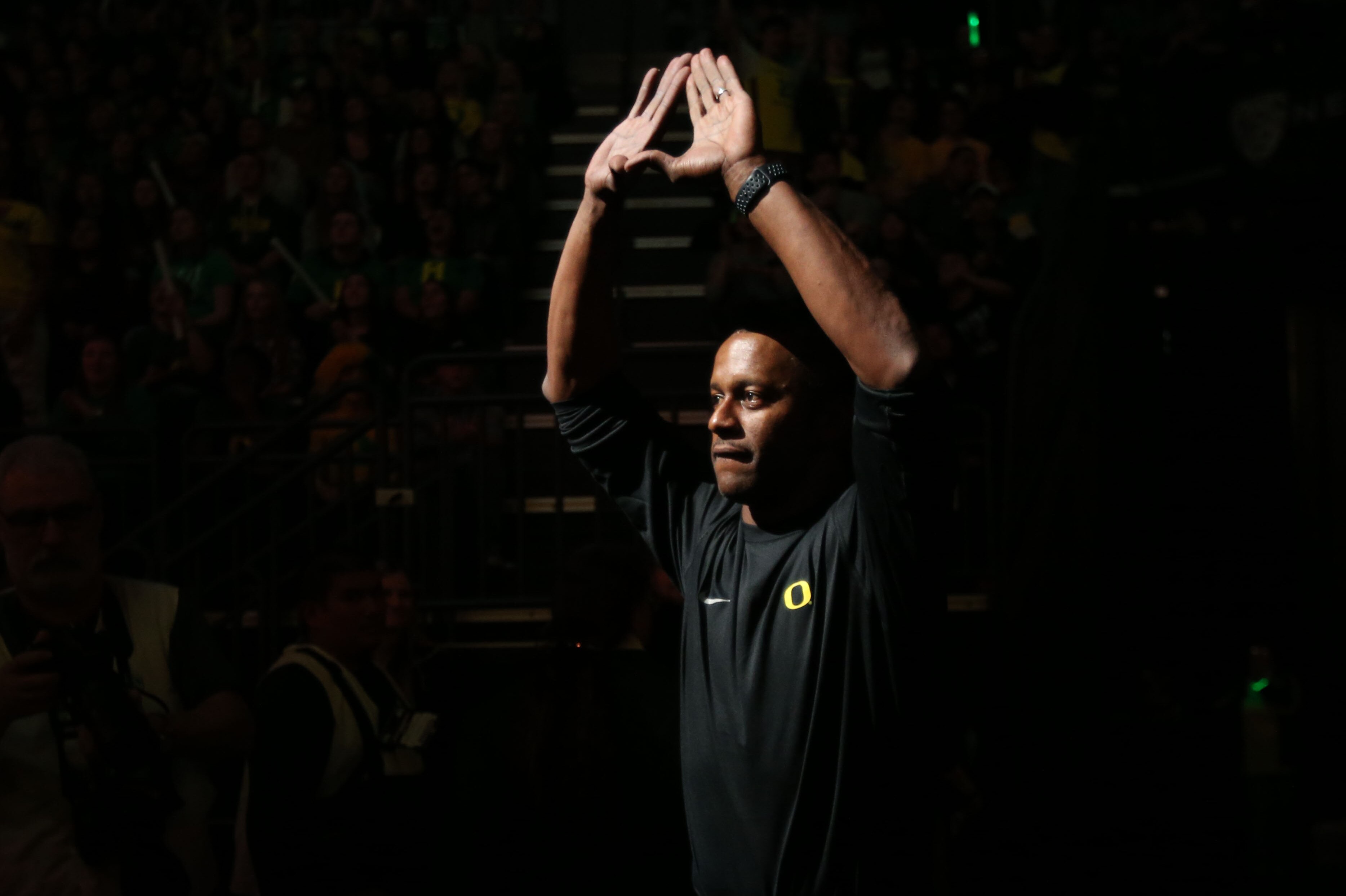 Oregon head football coach Willie Taggart flashed the sign of the O as he is intro ducted during halftime at the Oregon vs. Oregon State NCAA college basketball game Saturday, Jan. 14, 2017, in Eugene, Ore. (AP Photo/Chris Pietsch)