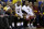 Cleveland Cavaliers' Kyrie Irving, from second from left, LeBron James, J.R. Smith and teammates sit on the bench during the second half of Game 2 of basketball's NBA Finals against the Golden State Warriors in Oakland, Calif., Sunday, June 5, 2016. (AP Photo/Marcio Jose Sanchez)