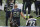 Seattle Seahawks center Justin Britt (68), and cornerback Jeremy Lane (20) stand near defensive end Michael Bennett (72) as Bennett sits on the bench during the national anthem before the team's NFL football preseason game against the Minnesota Vikings, Friday, Aug. 18, 2017, in Seattle. (AP Photo/Scott Eklund)
