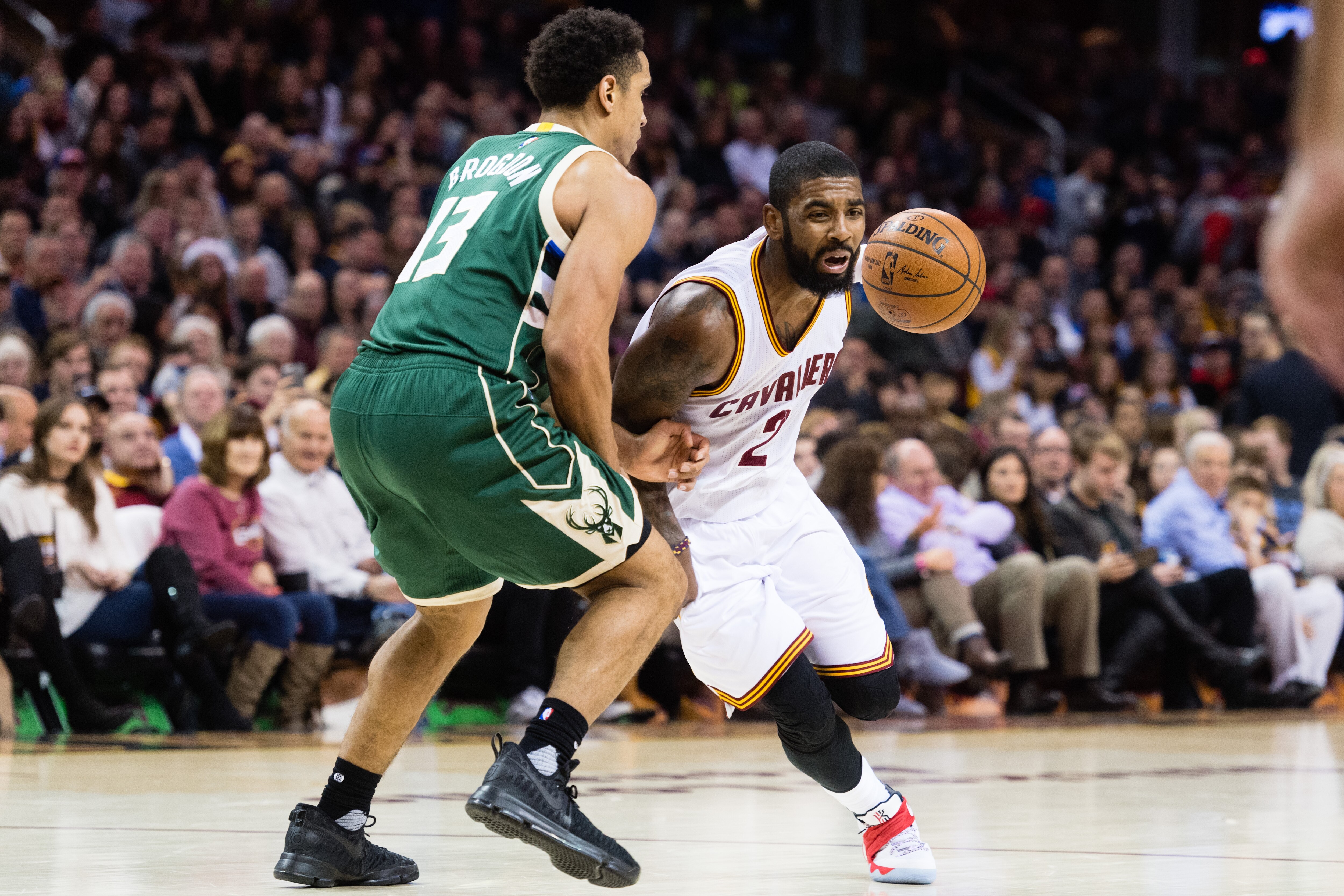 CLEVELAND, OH - DECEMBER 21: Kyrie Irving #2 of the Cleveland Cavaliers drives around Malcolm Brogdon #13 of the Milwaukee Bucks during the second half at Quicken Loans Arena on December 21, 2016 in Cleveland, Ohio. The Cleveland Cavaliers defeated the Bucks 113-102. NOTE TO USER: User expressly acknowledges and agrees that, by downloading and/or using this photograph, user is consenting to the terms and conditions of the Getty Images License Agreement. Mandatory copyright notice. (Photo by Jason Miller/Getty Images)