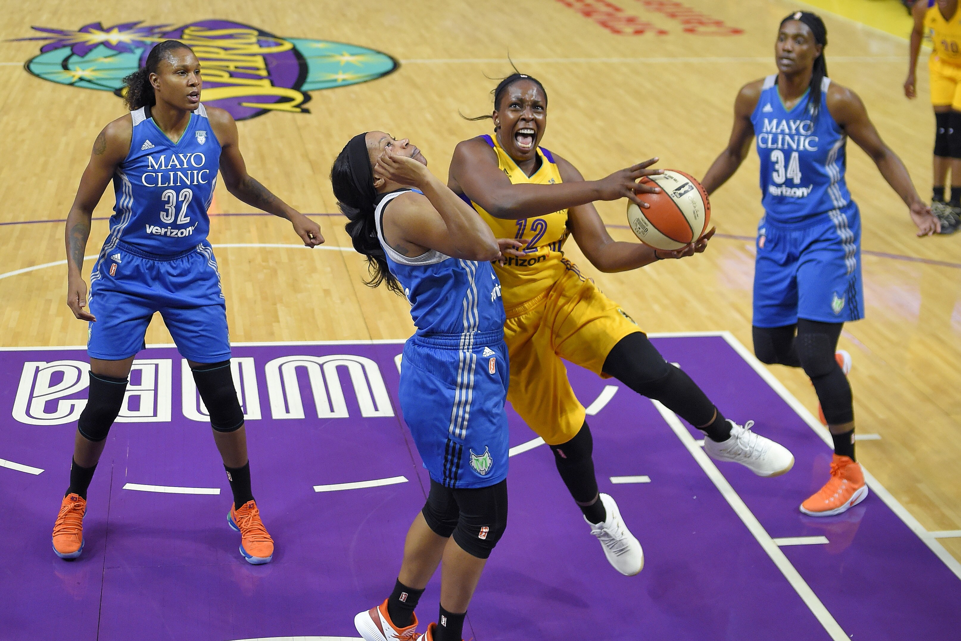 Los Angeles Sparks guard Chelsea Gray, second from right, shoots as Minnesota Lynx forward Rebekkah Brunson, left, guard Jia Perkins, second from left, and center Sylvia Fowles defend during the first half in Game 3 of a WNBA basketball finals game, Friday, Sept. 29, 2017, in Los Angeles. (AP Photo/Mark J. Terrill)
