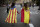 Irene Guszman, 15, wearing a Spanish flag on her shoulders and Mariona Esteve, 14, with an 'estelada' or independence flag, walk along the street to take part on a demonstration in Barcelona, Spain, Tuesday Oct.3, 2017. Thousands of people demonstrated against the confiscation of ballot boxes and charges on unarmed civilians during Sunday's referendum on Catalonia's secession from Spain that was previously declared illegal by Spain's Constitutional Court. (AP Photo/Emilio Morenatti)