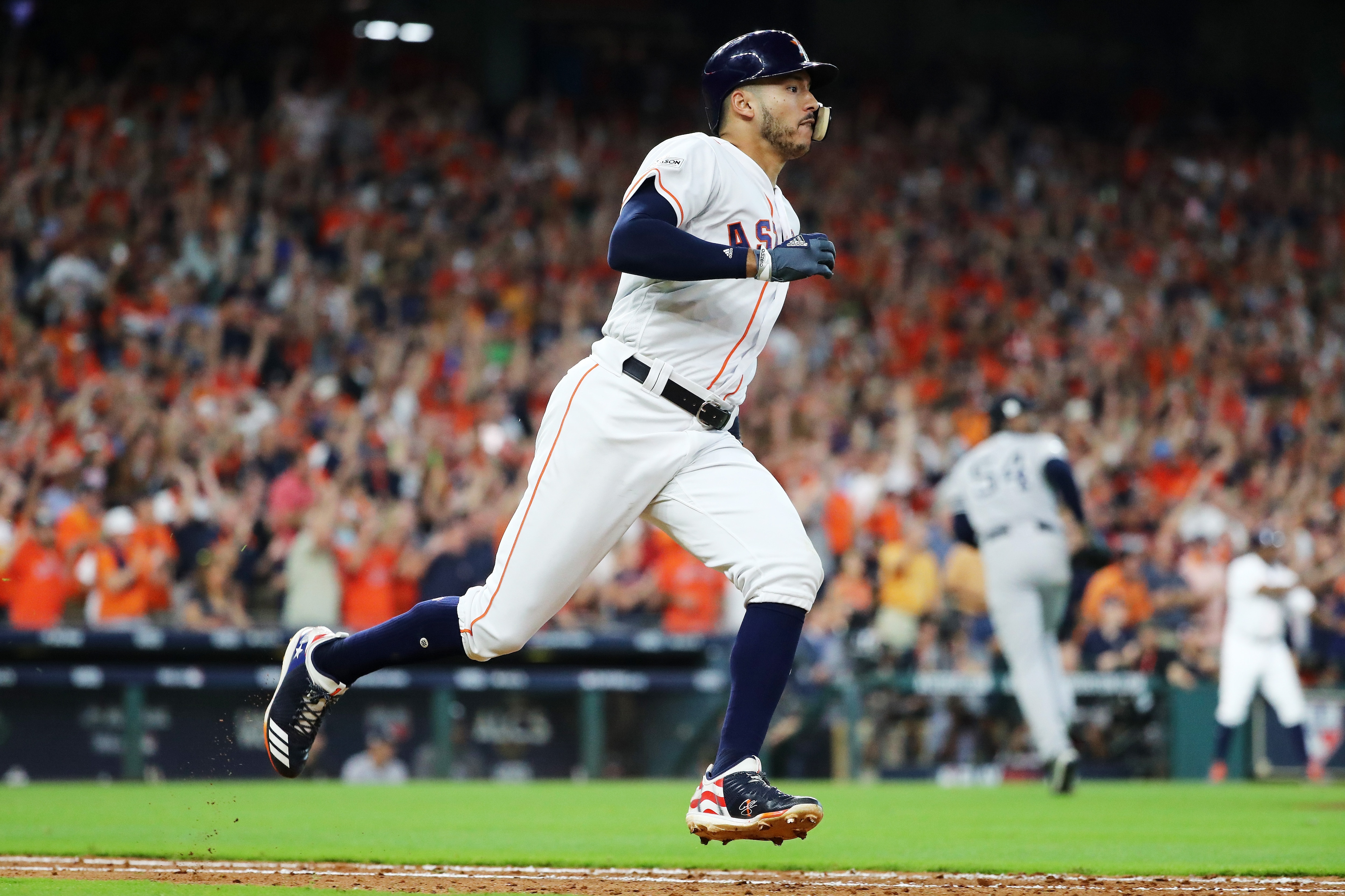 HOUSTON, TX - OCTOBER 14: Carlos Correa #1 of the Houston Astros runs to first on his double in the ninth inning scoring Jose Altuve #27 of the Houston Astros to defeat the New York Yankees 2 to 1 in game two of the American League Championship Series at Minute Maid Park on October 14, 2017 in Houston, Texas. (Photo by Elsa/Getty Images)