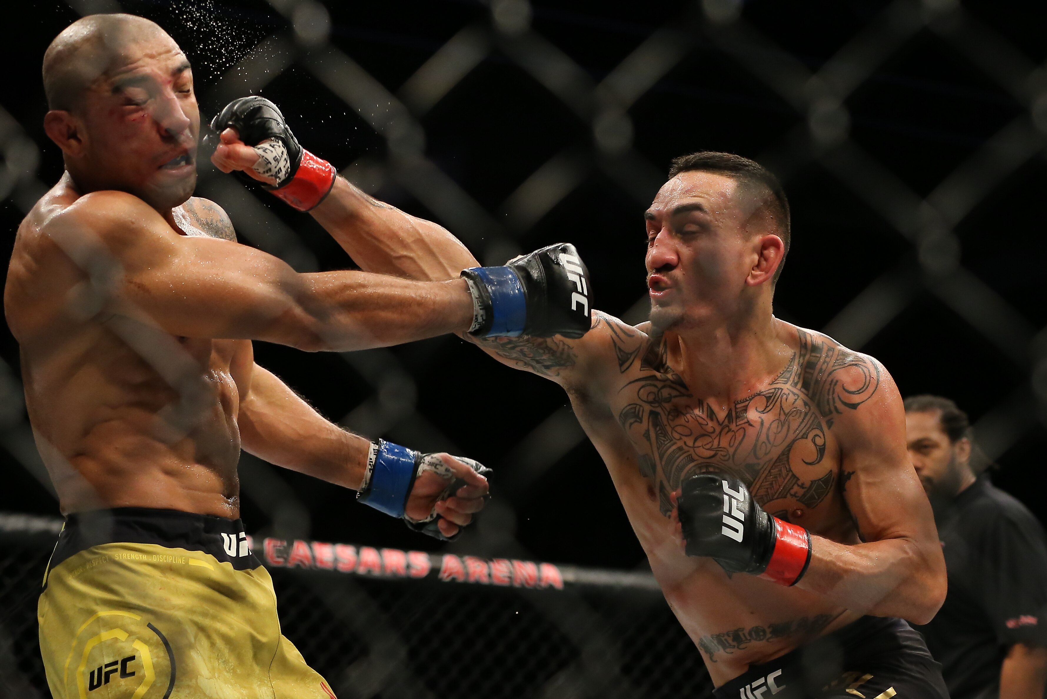 DETROIT, MI - DECEMBER 2: (R) Max Holloway punches Jose Aldo during the UFC 218 event at Little Caesars Arena on December 2, 2017 in Detroit, Michigan. (Photo by Rey Del Rio/Getty Images)