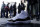 A newly-purchased Air Jordans sneaker is shown in front of a line of customers at the Nike Store at Union Square Friday, Dec. 23, 2011 in San Francisco. The release of Nike's retro Air Jordans caused a frenzy at stores across the nation early Friday, with hundreds of people lining up for a chance to buy the classic basketball shoes and rowdy crowds breaking down doors and starting fights in at least two cities. (AP Photo/Marcio Jose Sanchez)