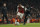 Arsenal's Joe Willock, left, holds off the challenge of West Ham United's Domingos Quina during the English League Cup quarterfinal soccer match between Arsenal and West Ham United at the Emirates stadium in London, Tuesday, Dec. 19, 2017. (AP Photo/Alastair Grant)