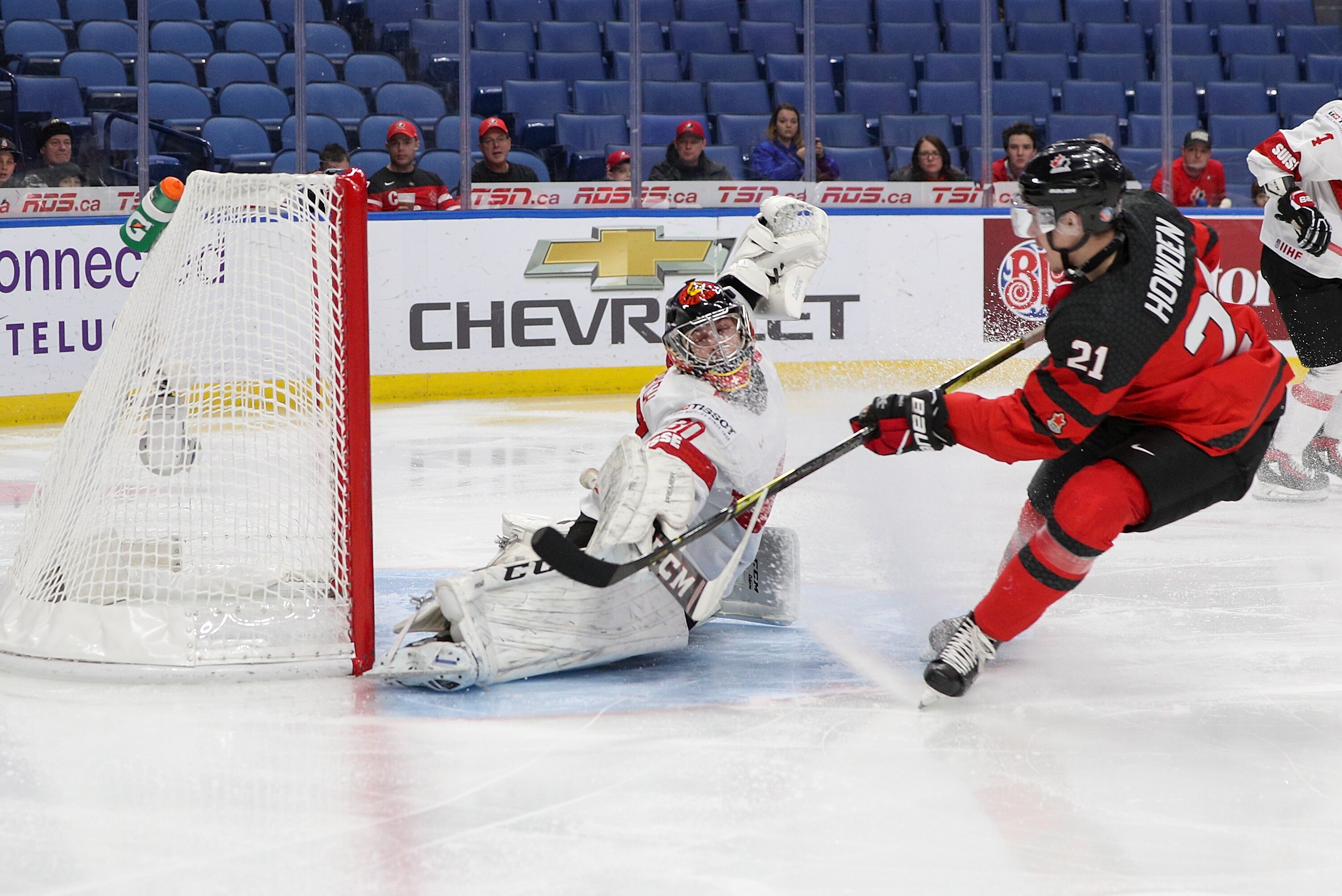 BUFFALO, NY - JANUARY 02: Brett Howden #21 of Canada scores past Philip Wüthrich #30 of Switzerland for team Canada's first goal during the first period of play in the Quarterfinal IIHF World Junior Championship game at the QeyBank Center on January 2, 2018 in Buffalo, New York. (Photo by Nicholas T. LoVerde/Getty Images)