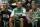 Boston Celtics point guard Rajon Rondo (9), guard Ray Allen (20) and forward Paul Pierce (34) watch the final minutes tick away from the bench in the second half of an NBA basketball game in Charlotte, NC, Saturday, Dec. 11, 2010. The Boston Celtics won 93-62. (AP Photo/Bob Leverone)